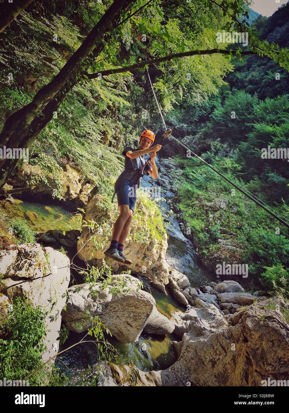Teenage boy on a zip wire Bagni Di Lucca Italy Stock Photo