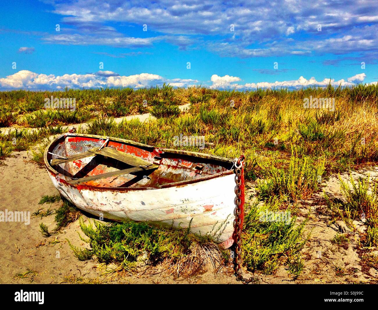 Old life boat on sandy shore Stock Photo