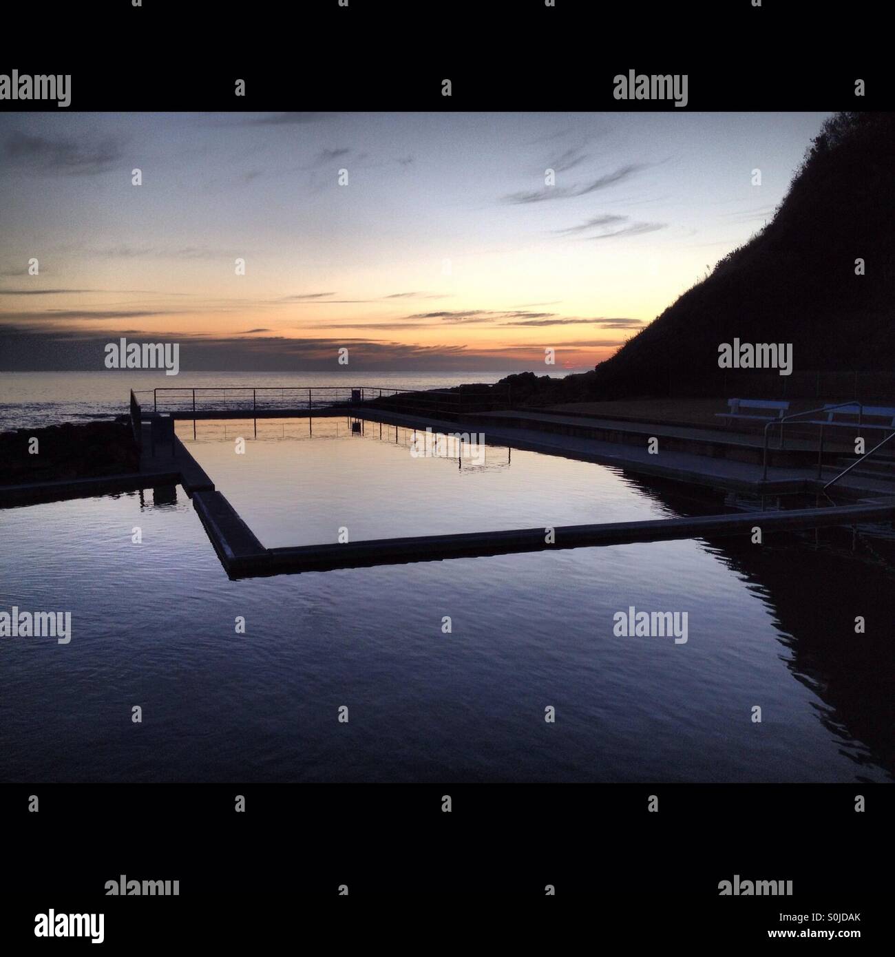 Pre dawn, pre sunrise shot of the ocean pool at Black Head Beach on the mid north coast of New South Wales, Australia - Smartphone Captured Stock Image