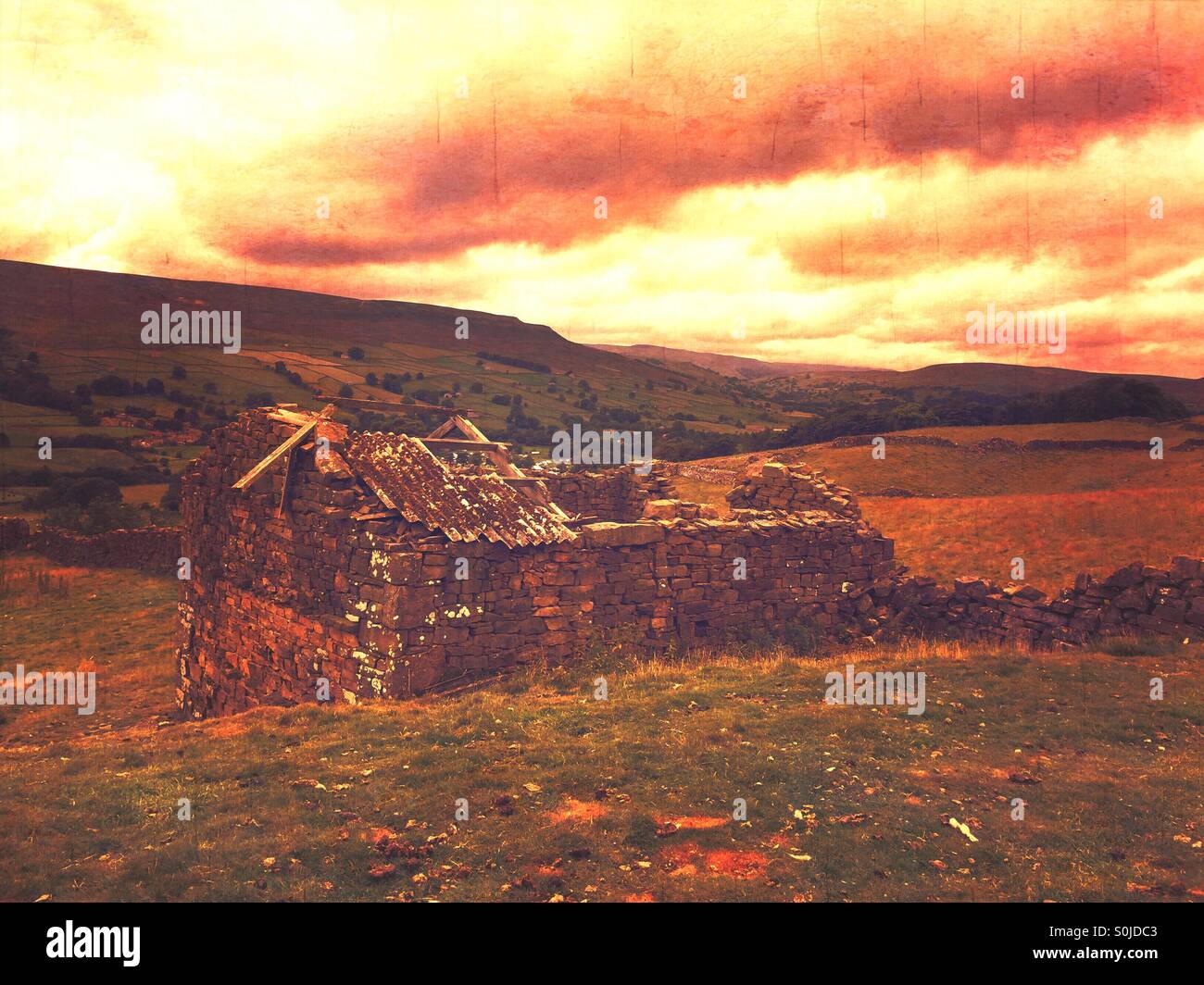 Ruins on a hillside, slowly falling apart a stone building Stock Photo