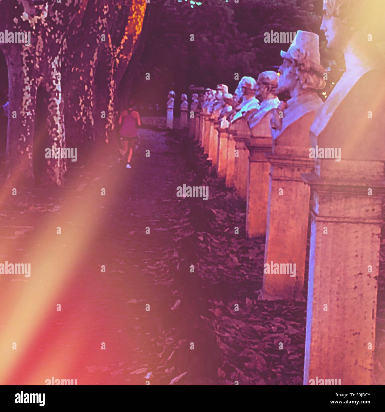 Runner passing line of statues on Janiculum Hill Rome at sunset - Smartphone Captured Stock Image