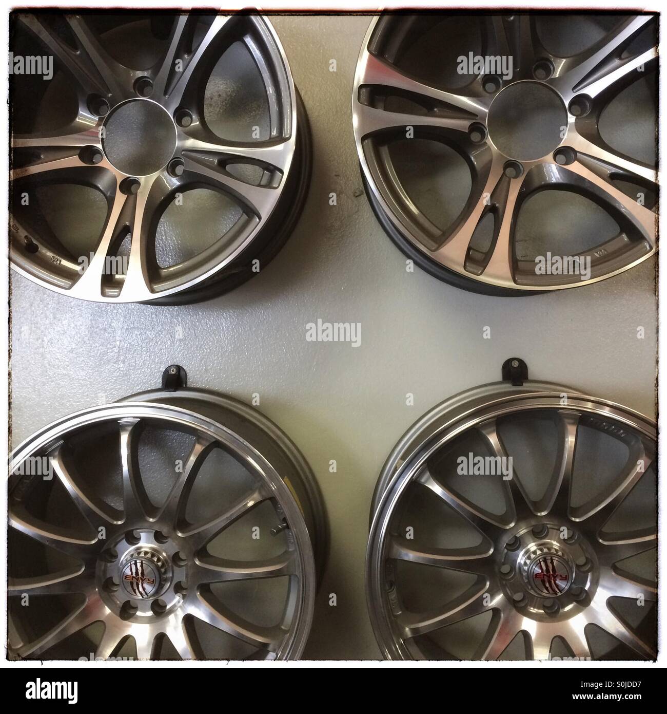 Car rims on display in workshop. - Smartphone Captured Stock Image