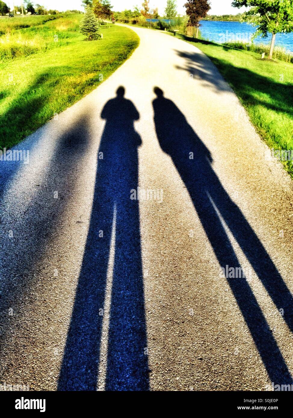 Two tall shadows with tiny heads (1) - Smartphone Captured Stock Image