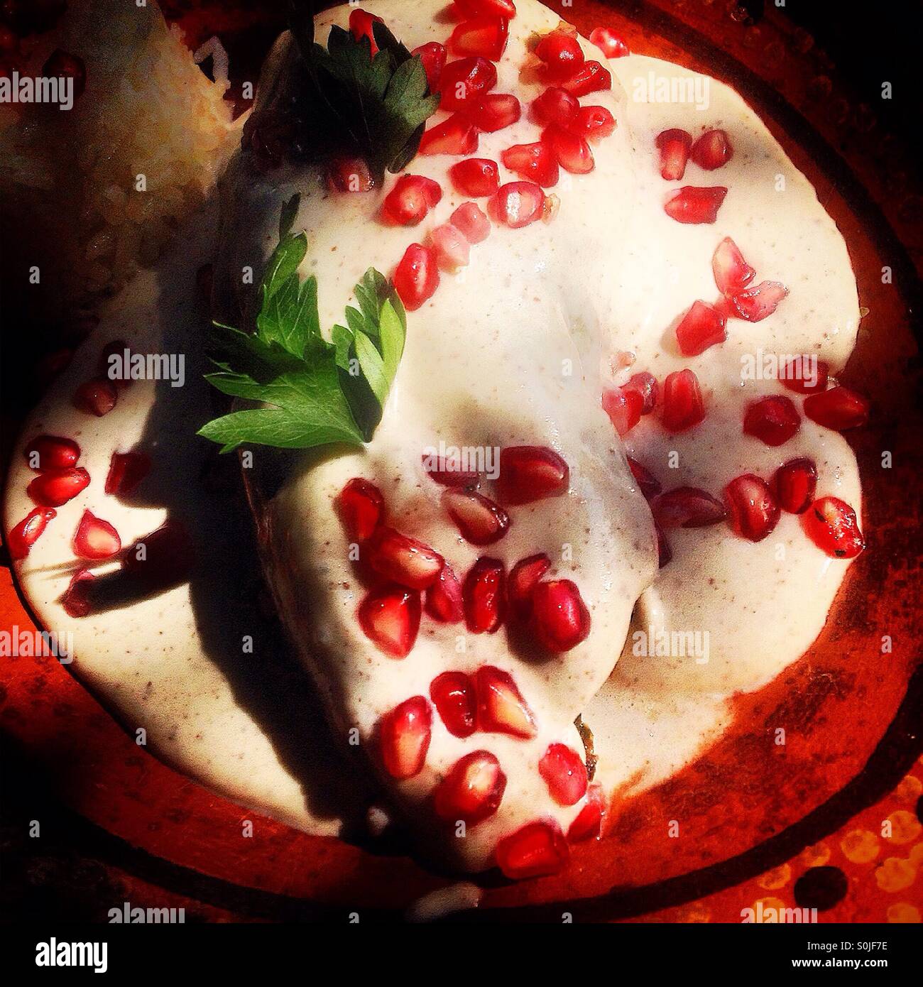 A chiles en nogada plate in a restaurant in Colonia Roma, Mexico City, Mexico - Smartphone Captured Stock Image