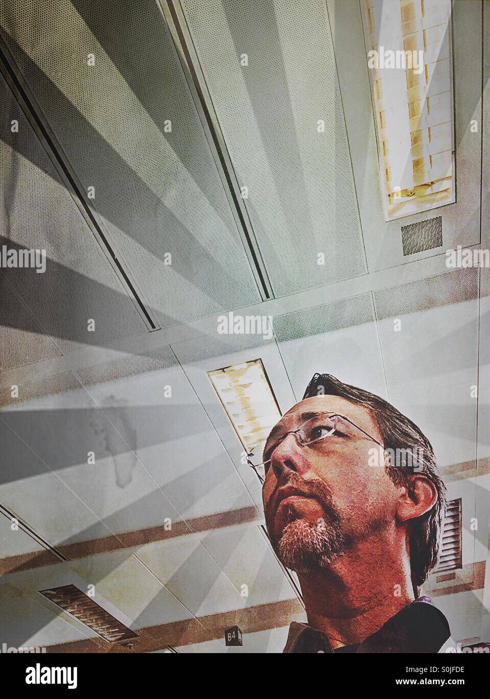 Radiating head of man in office. - Smartphone Captured Stock Image