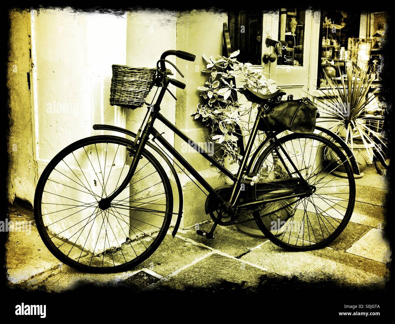 Old bicycle outside antique shop Stock Photo