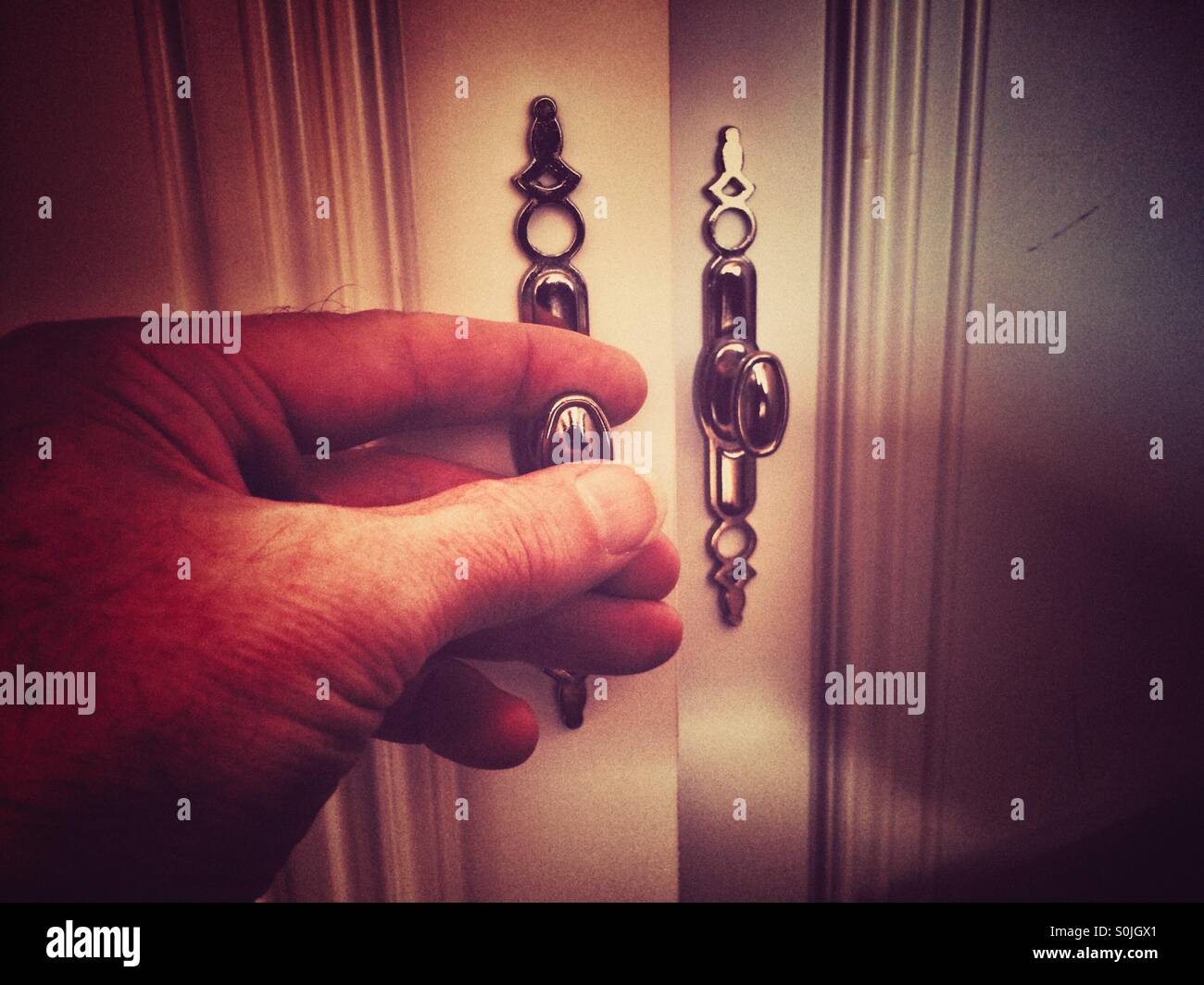 Opening a cupboard door - Smartphone Captured Stock Image