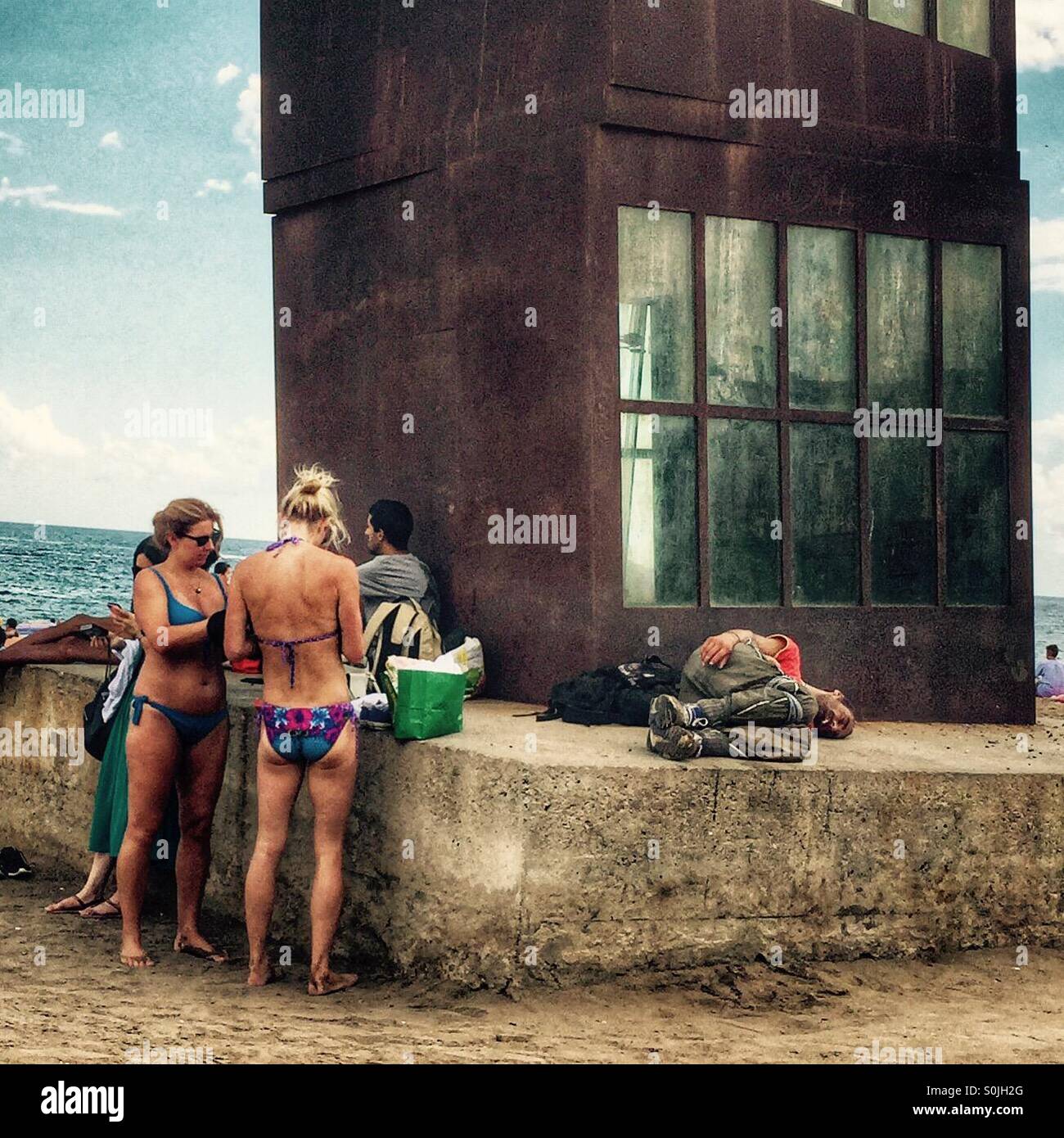 Homless man slepping at Barcelonetta Beach Stock Photo