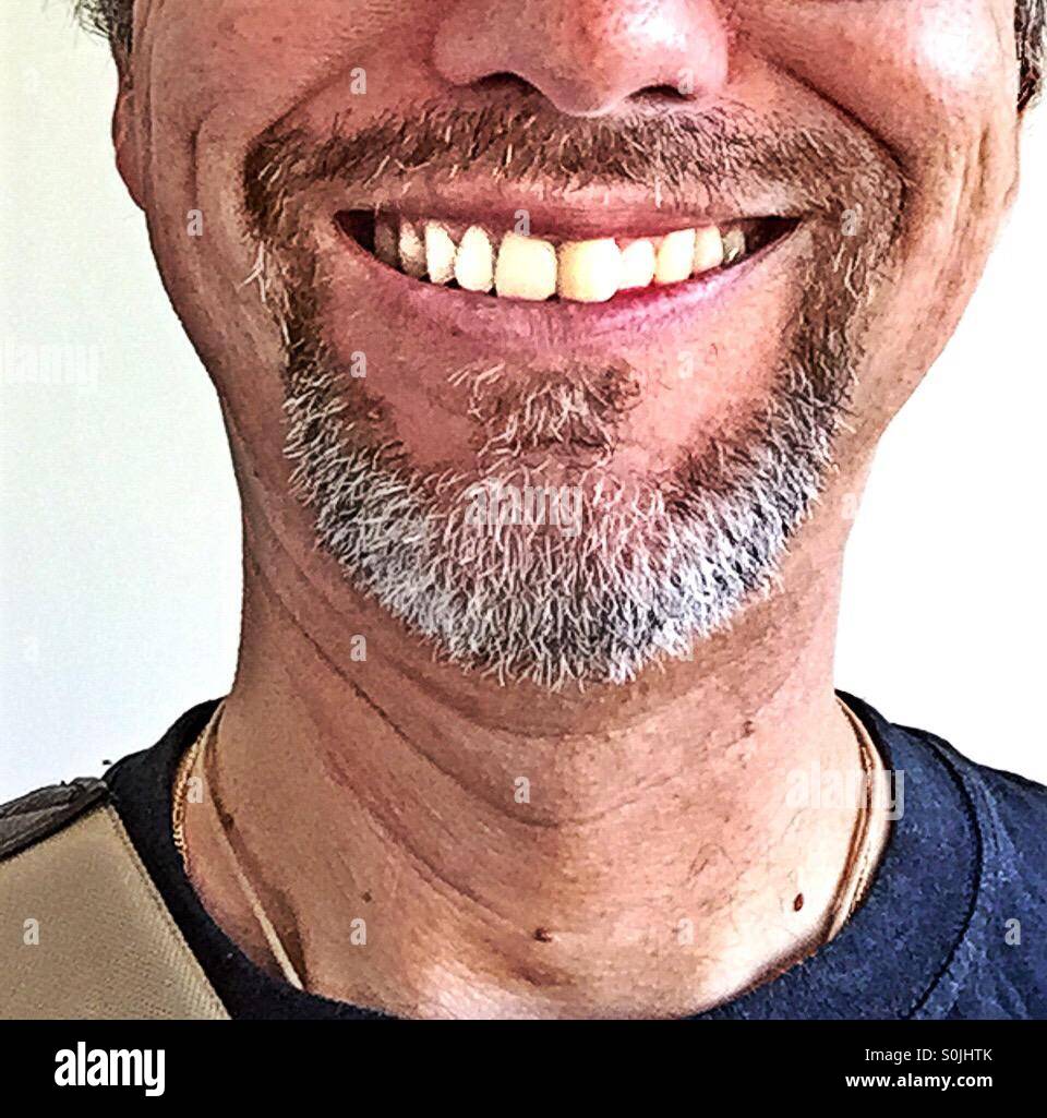 Cut off portrait of a man with a goatee smiling - Smartphone Captured Stock Image