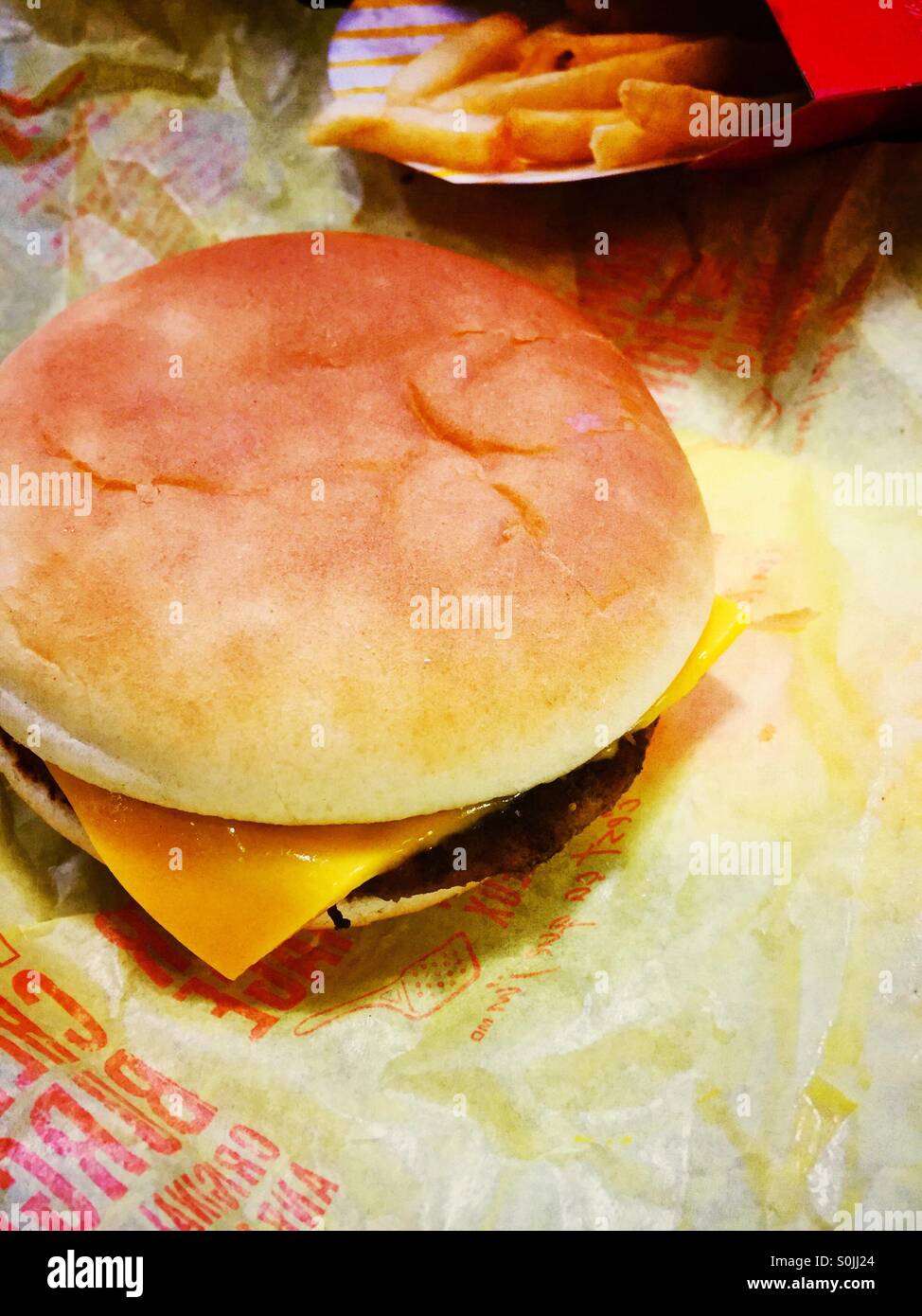Cheeseburger and fries. Stock Photo