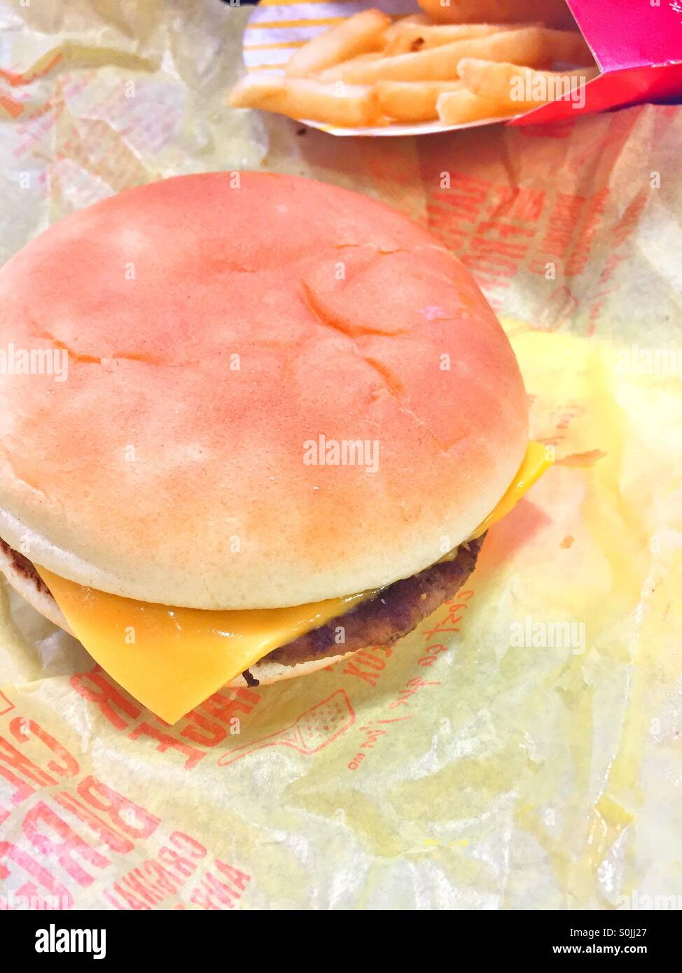 Cheeseburger and fries. Stock Photo