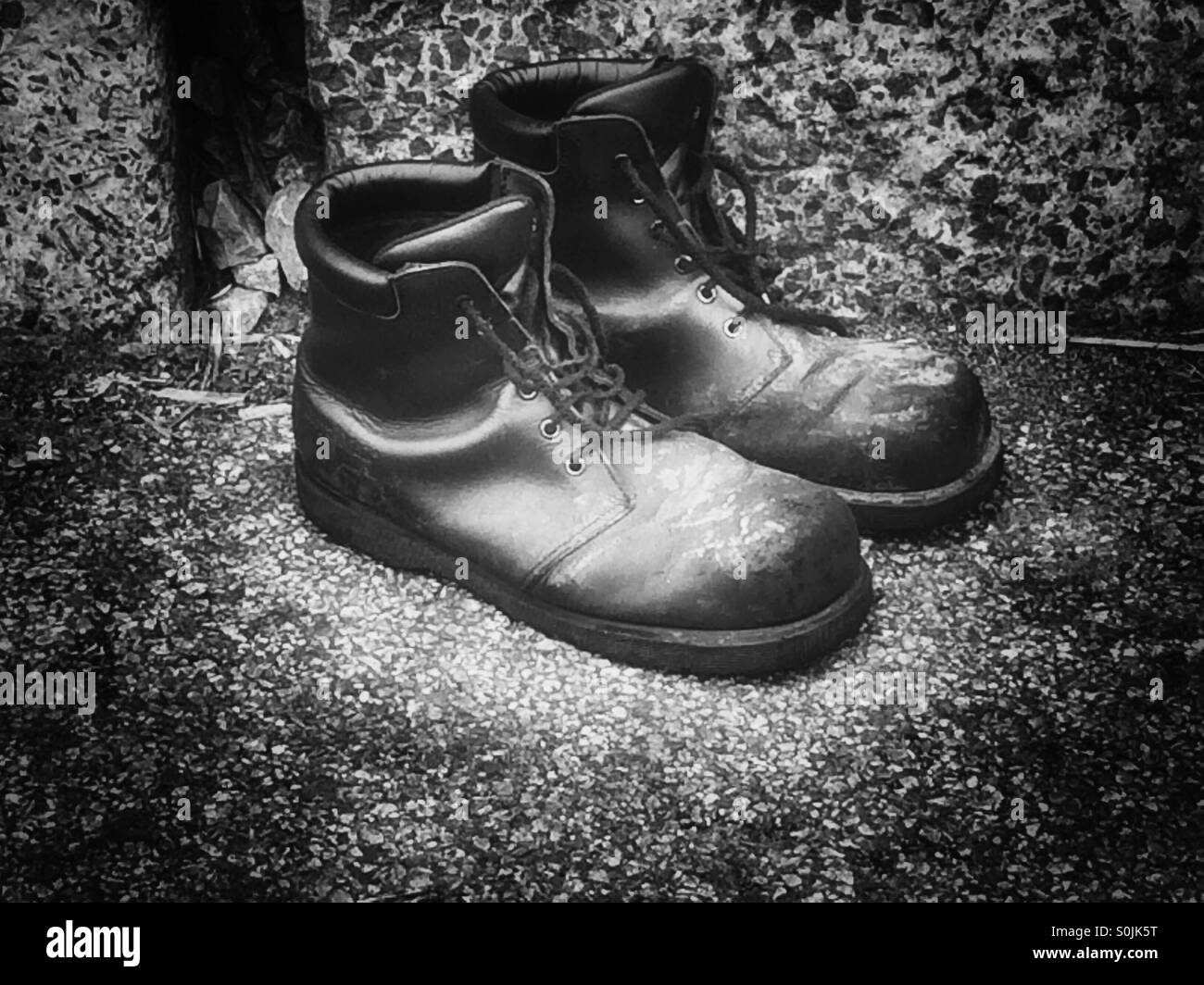 A pair of marked and stained work boots. - Smartphone Captured Stock Image