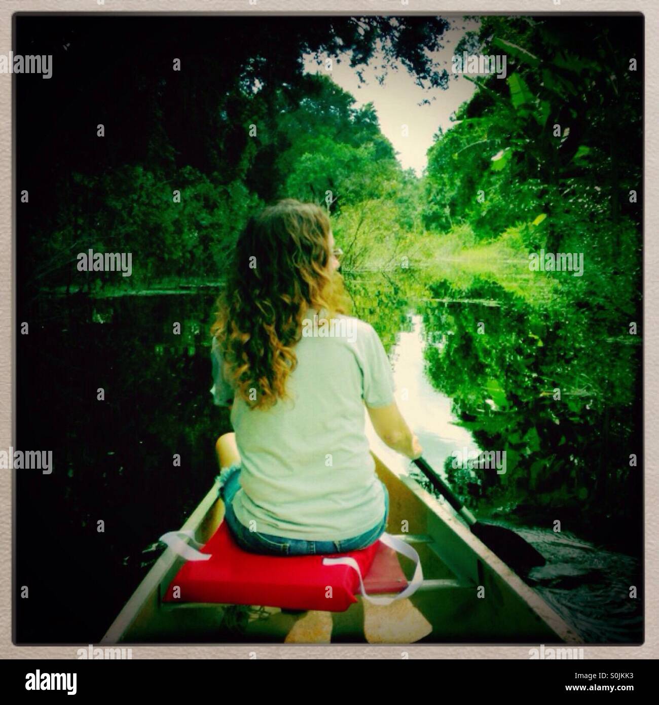 Woman paddling a canoe Stock Photo