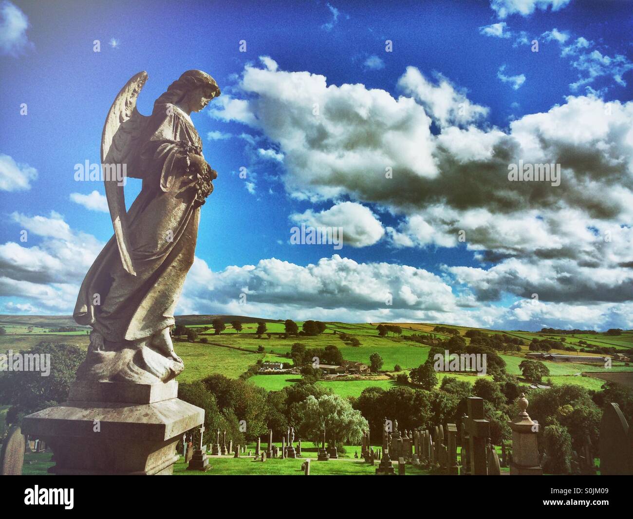 Statue of an angel watching over a cemetery. Stock Photo