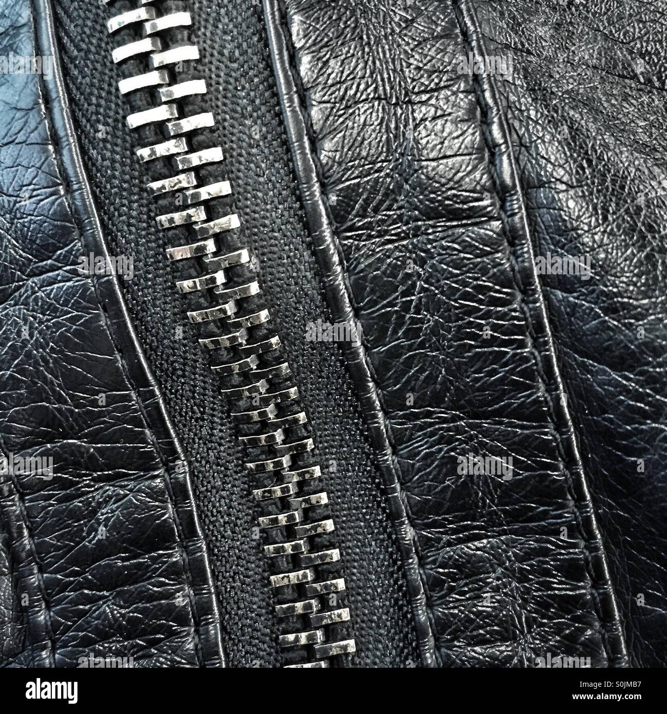 Closeup of a closed zipper and black leather jacket - Smartphone Captured Stock Image
