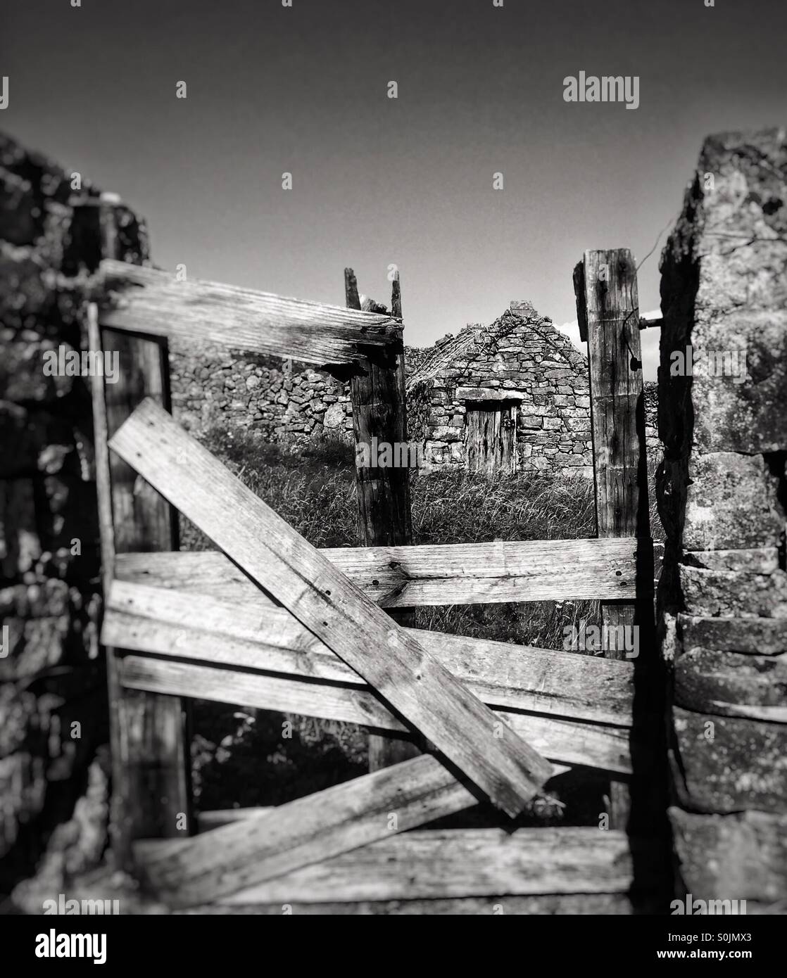 Broken gate and cottage Stock Photo Alamy
