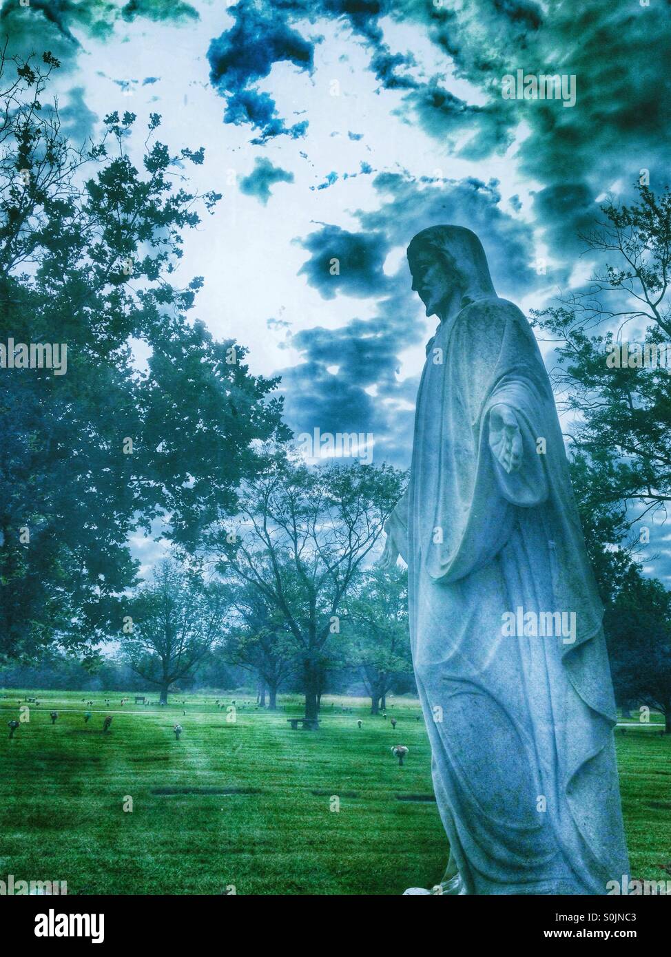 A side view of a Jesus statue with arms opened (2). - Smartphone Captured Stock Image