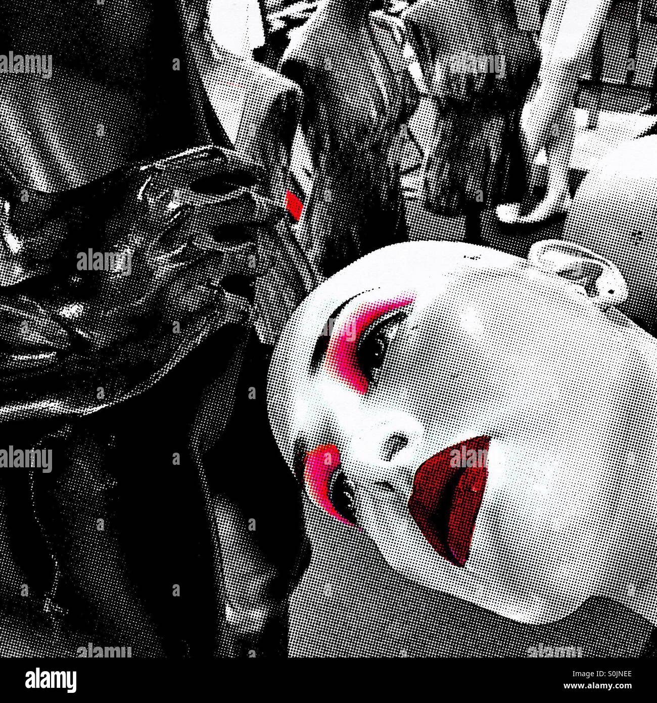 An abstract image of the face of a bald mannequin that is heavily made up, amidst other mannequins. - Smartphone Captured Stock Image