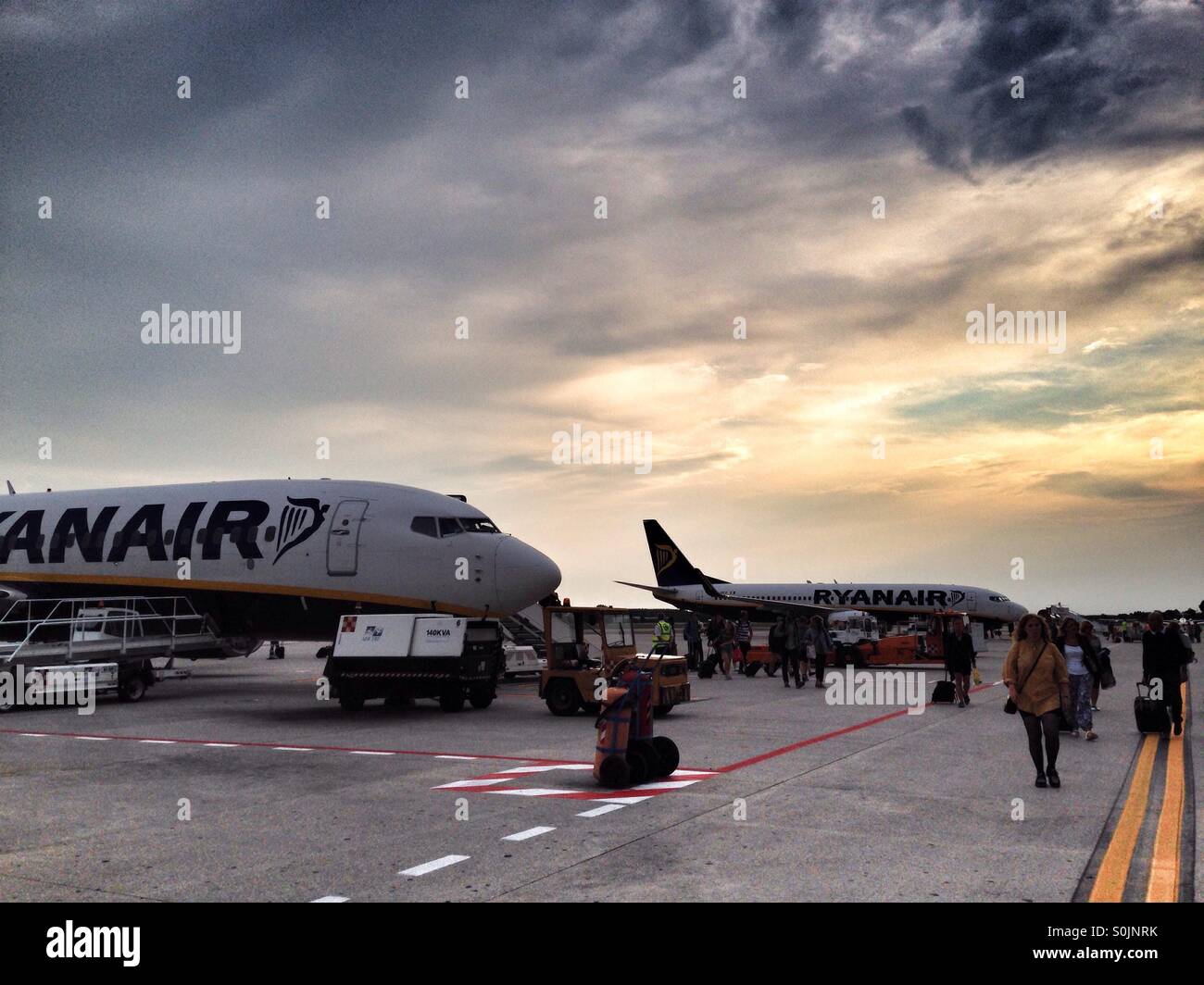 Arriving in the Venice Treviso airport, Italy, coming from the Billund airport, in Jutland, Denmark, in a Ryanair flight. Nice sunset in the background, golden light and blue and cloudy sky - Smartphone Captured Stock Image