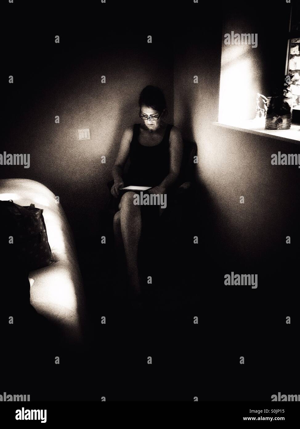 Woman using tablet in bedroom - Smartphone Captured Stock Image