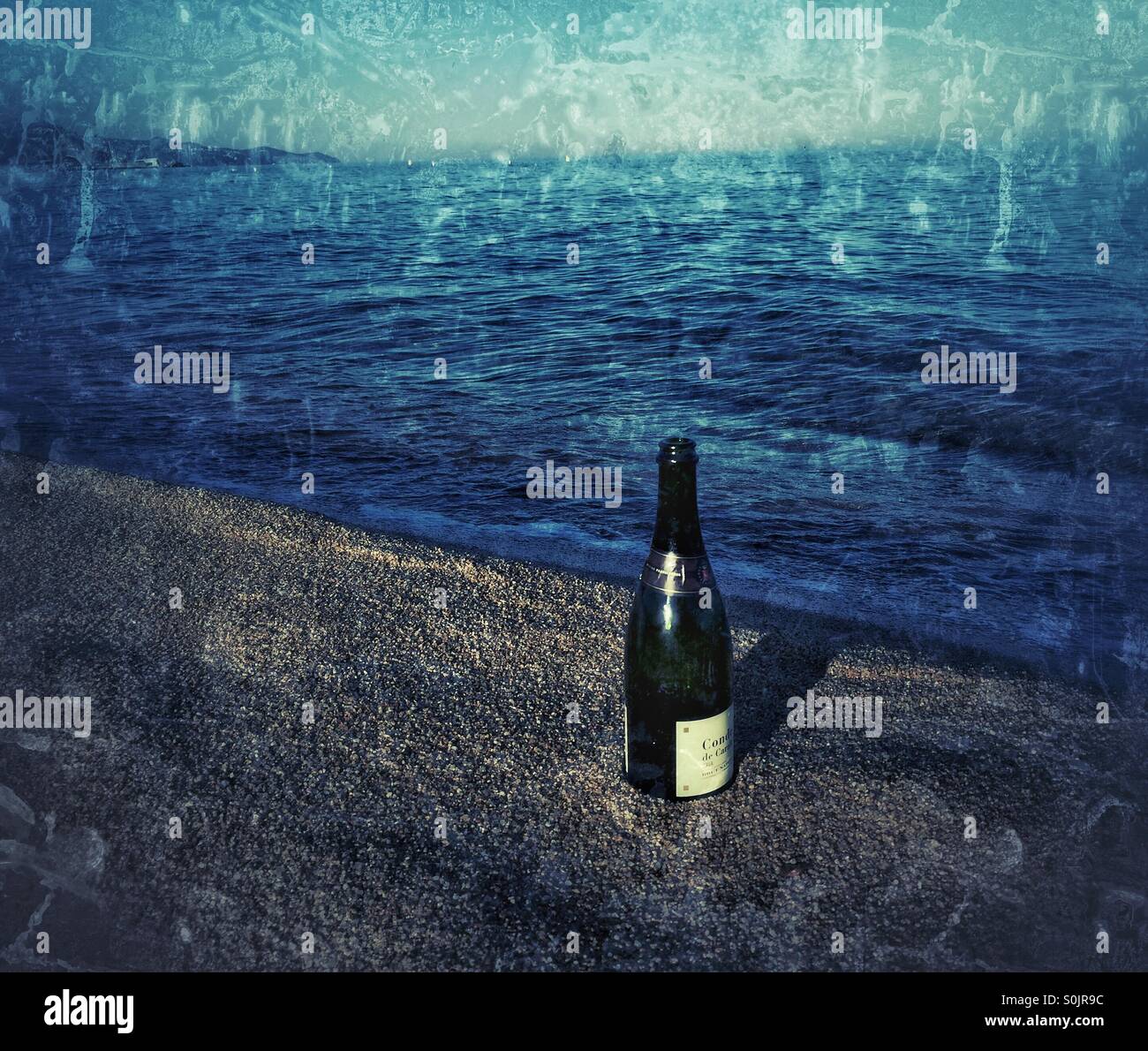 Emply bottle on the beach - Smartphone Captured Stock Image