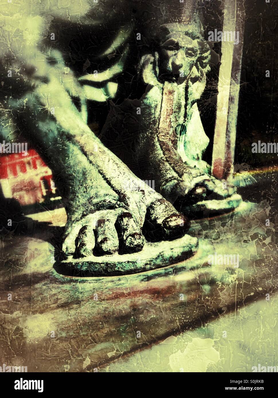 Close up of feet in sandals on a bronze statue - Smartphone Captured Stock Image