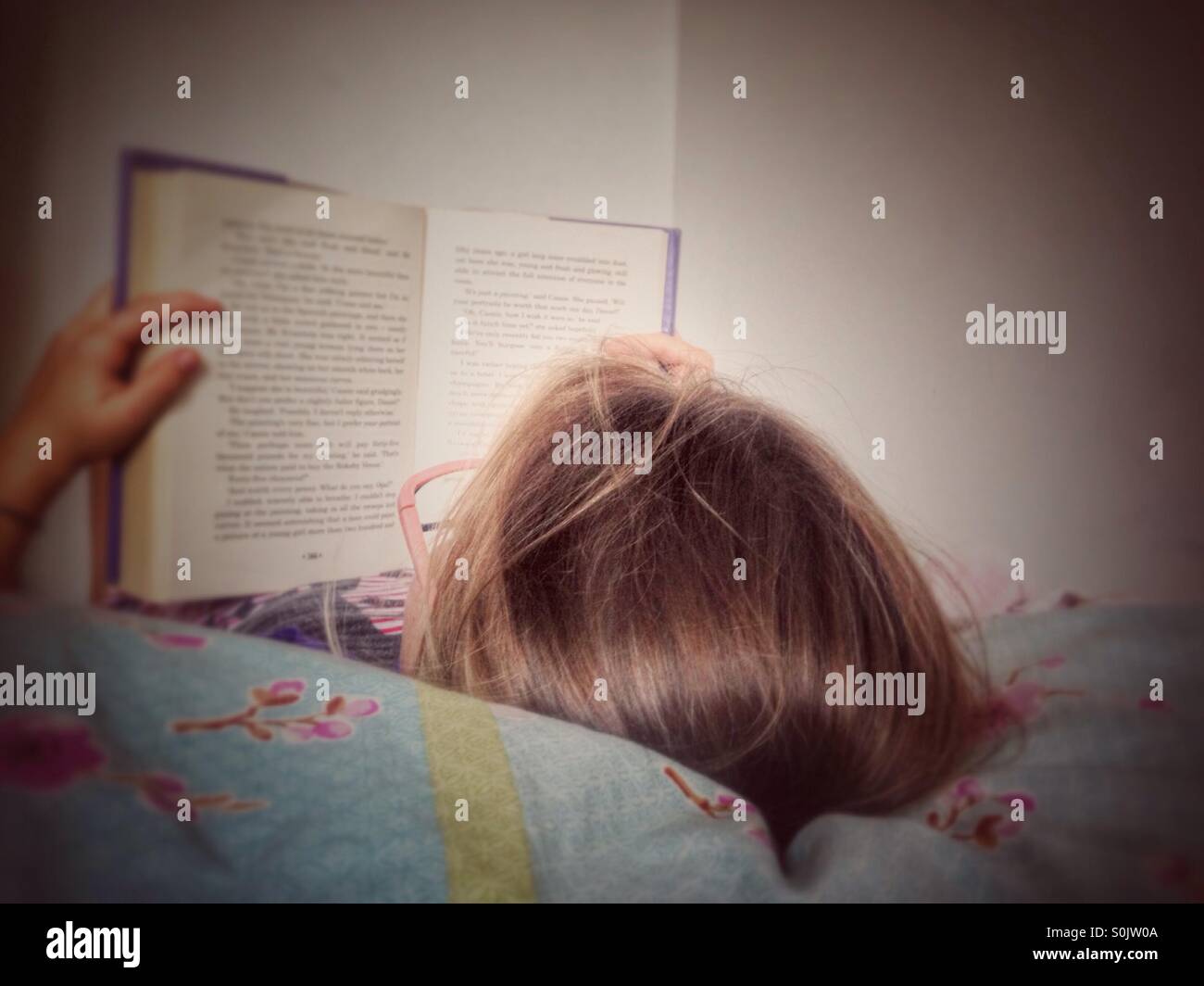 Child reading in bed. - Smartphone Captured Stock Image