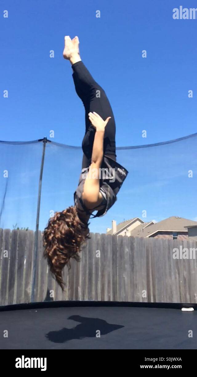 Girl on trampoline caught upside down Stock Photo Alamy