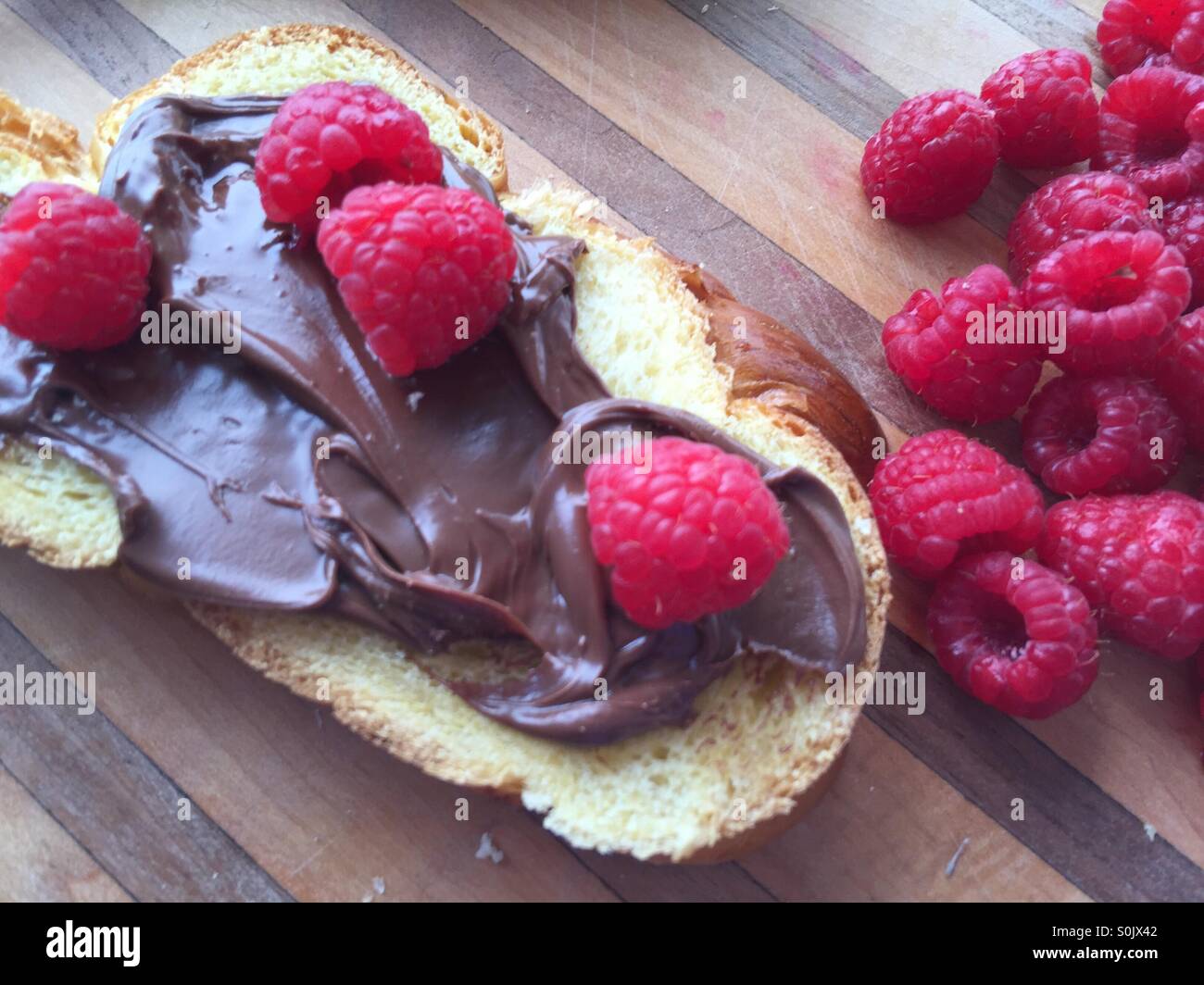Raspberries and chocolate spread on brioche - Smartphone Captured Stock Image