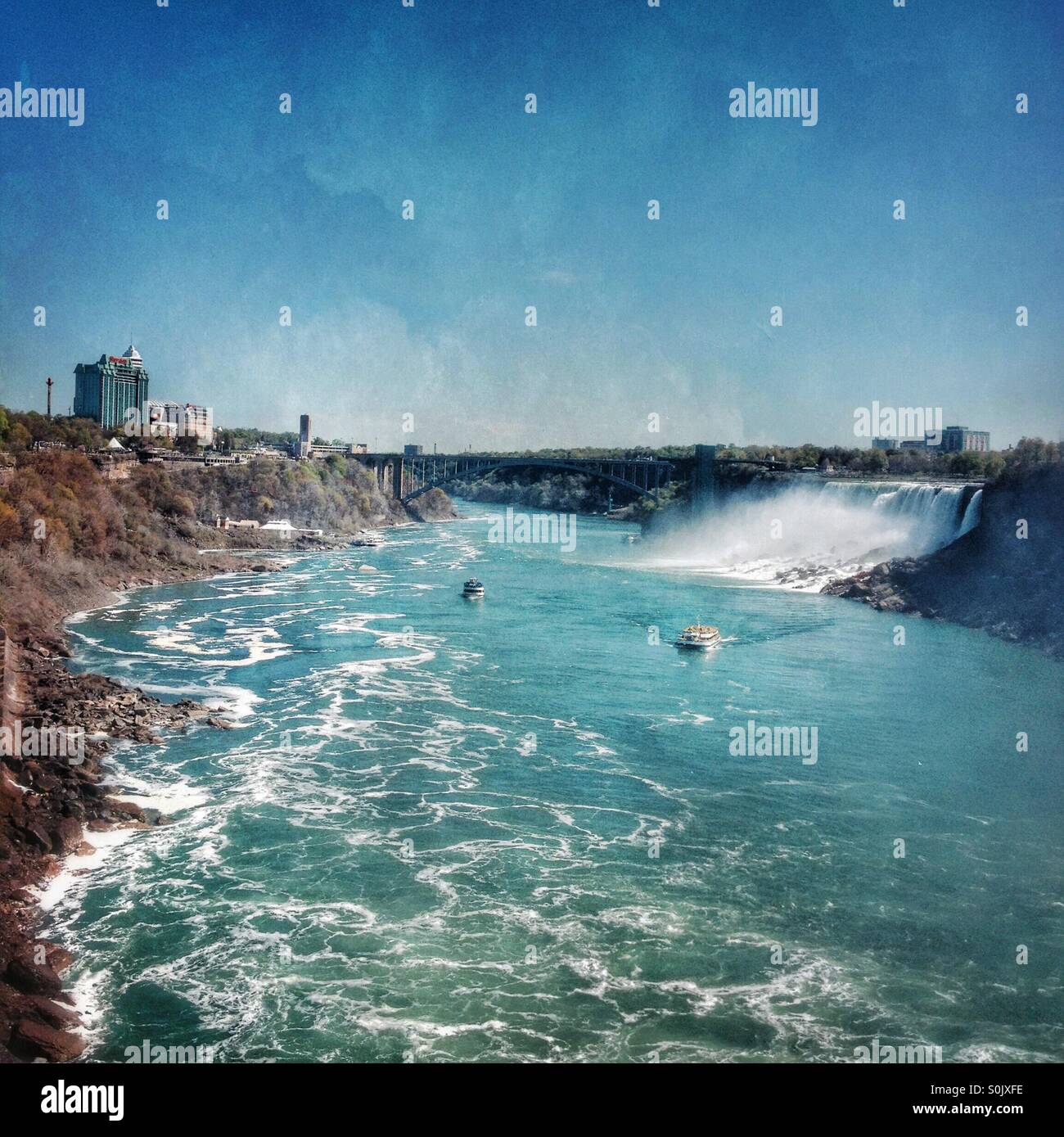 View from canadian side of Niagara Falls to American side of Niagara Falls with boats on the river below - Smartphone Captured Stock Image