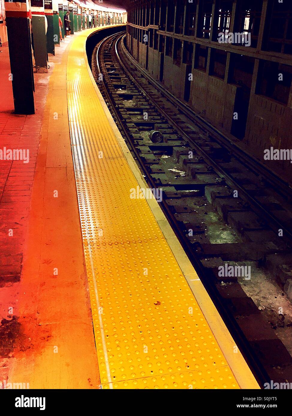 Subway platform yellow safety strip and tracks, New York City. Stock Photo