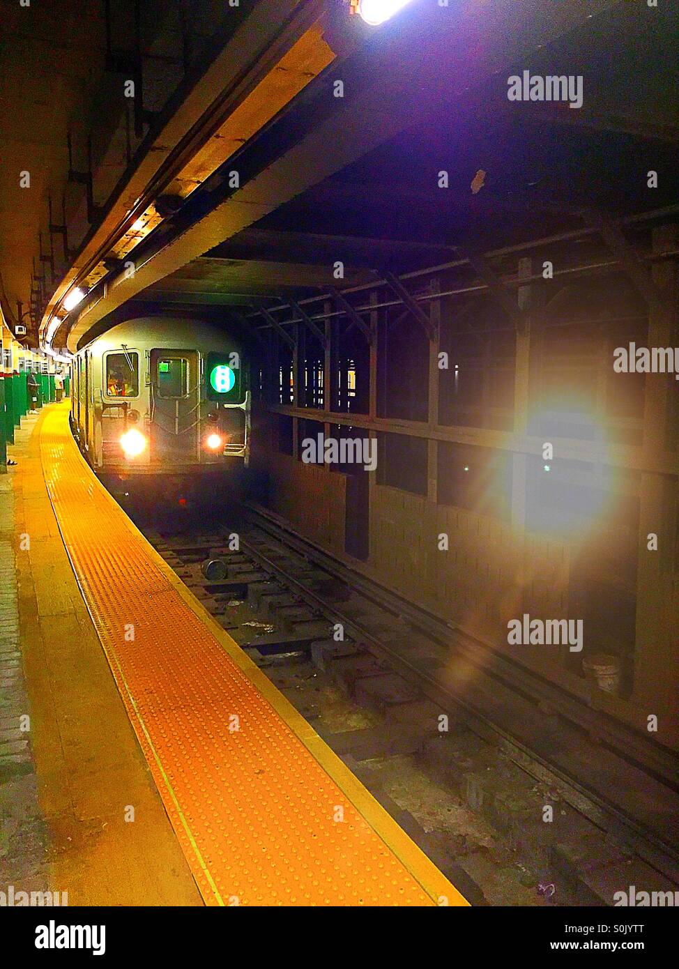 Six line subway train arrives at Astor Place station, New York City. Stock Photo