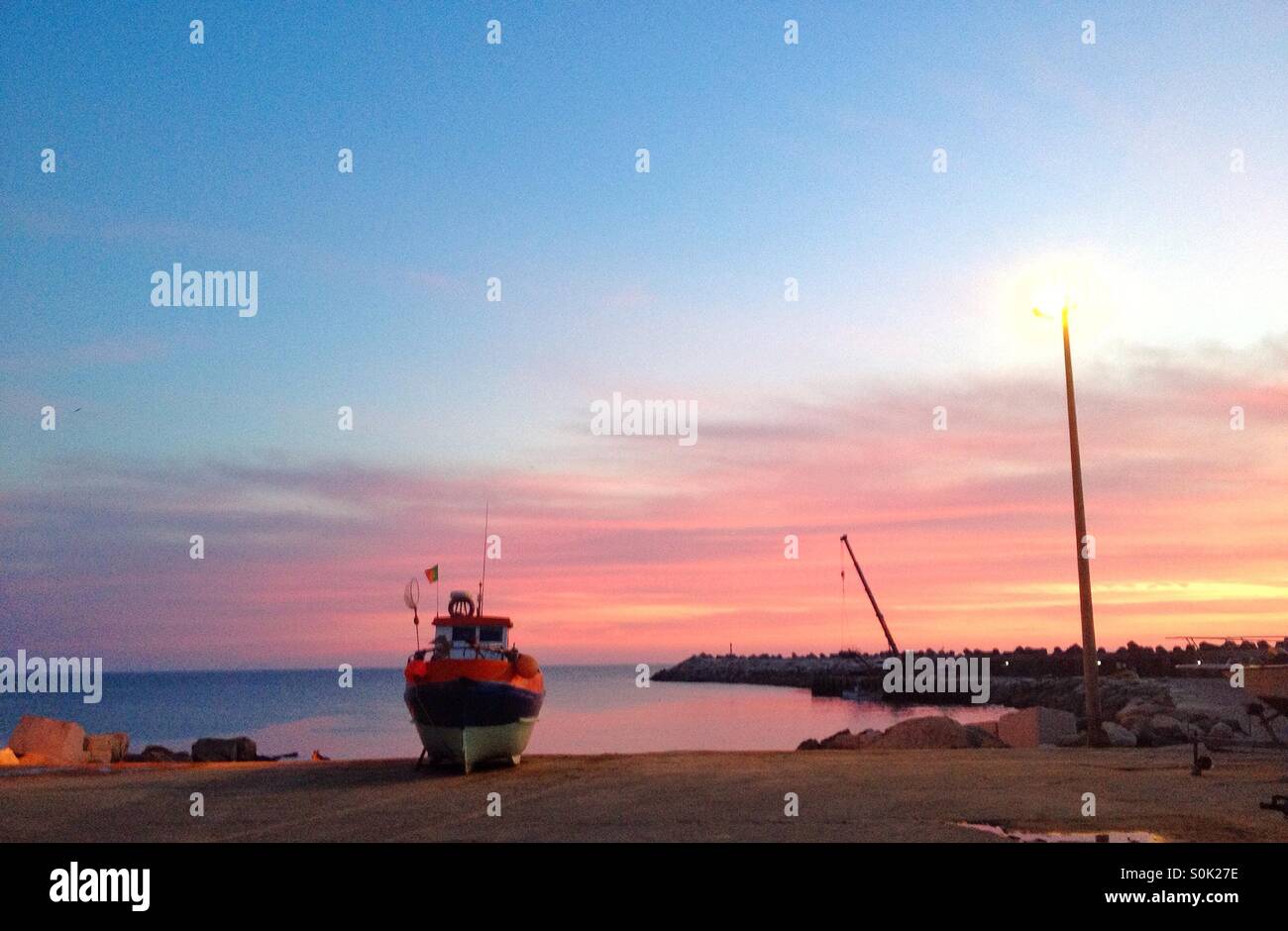 Fishing boat at sunset Stock Photo