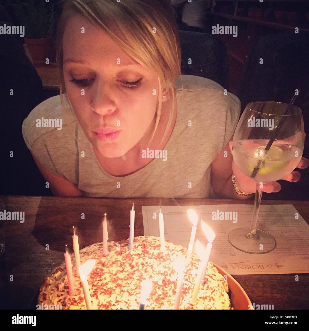 Girl blowing out candles Stock Photo Alamy