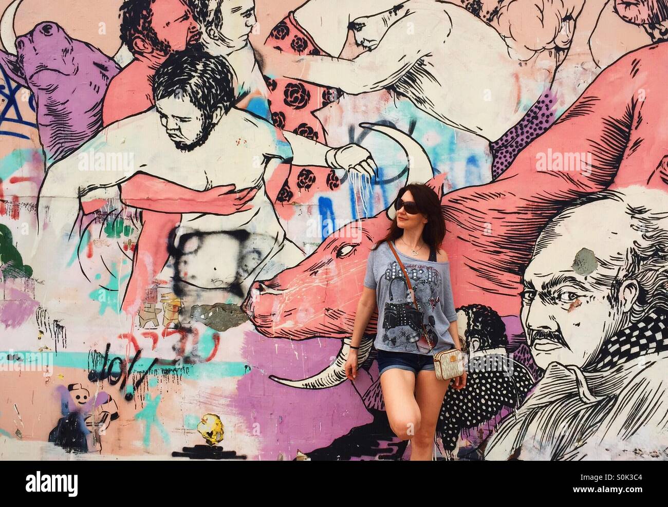 girl stand near graffiti wall Stock Photo