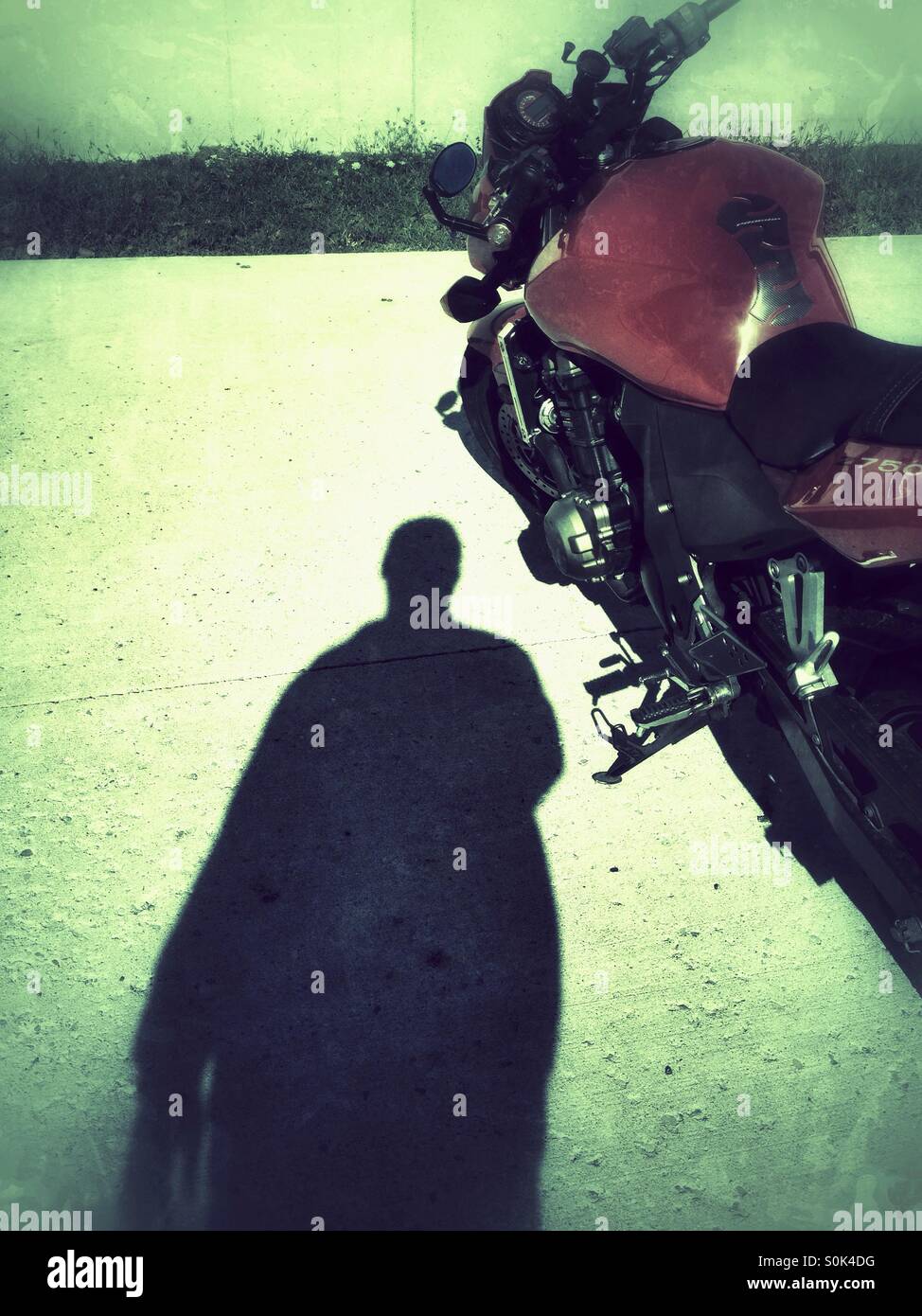 Biker walking towards a parked motorcycle Stock Photo Alamy