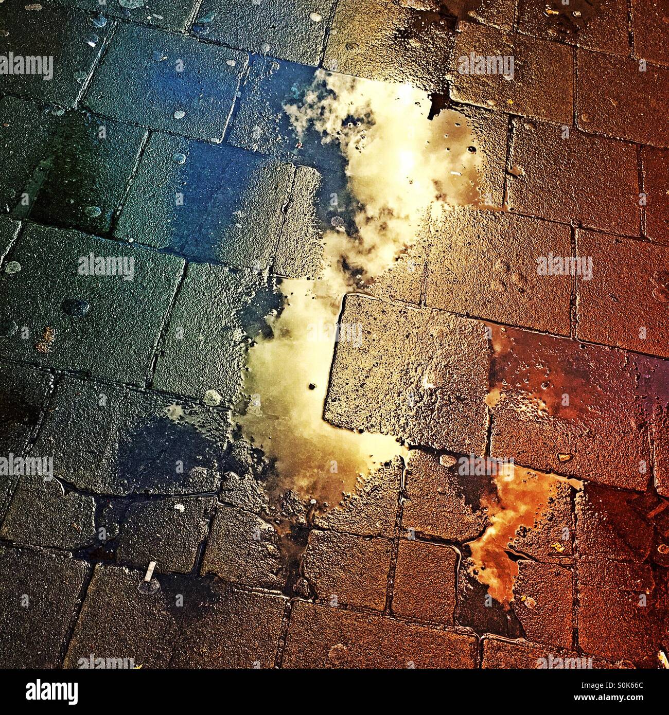 Rainy day. Cloud reflecting in puddle after a rainstorm. - Smartphone Captured Stock Image