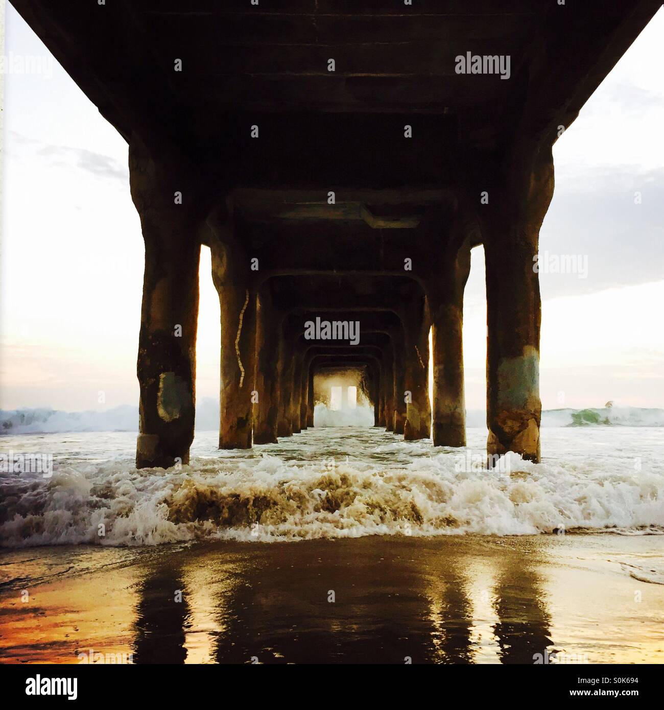 Waves crashing under the pier. Manhattan Beach California USA. - Smartphone Captured Stock Image
