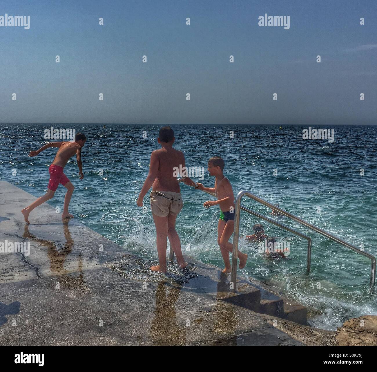 Teens jumping in sea - Smartphone Captured Stock Image
