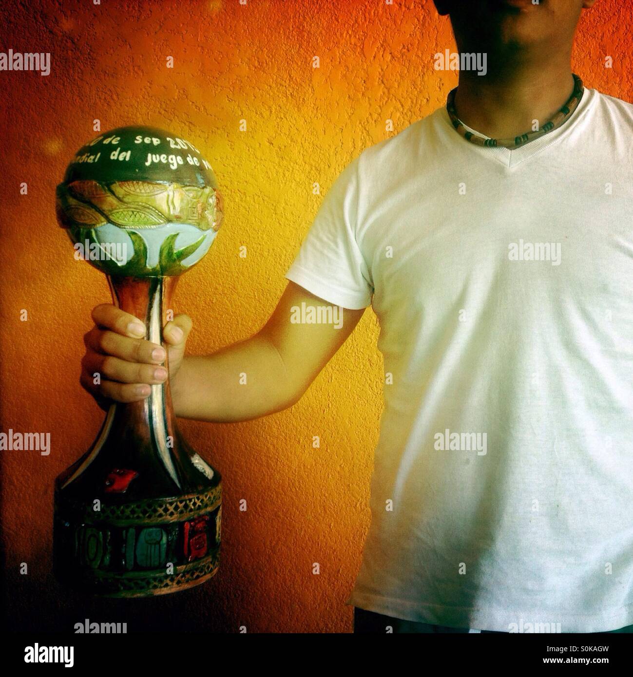 A man holds the main trophy of the first ¨Pok Ta Pok¨ Mayan ball game World Cup in Merida, Yucatan, Mexico. Stock Photo