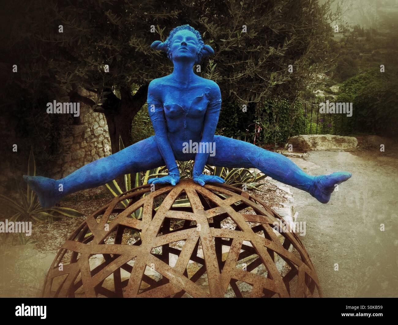 Sculpture of a blue woman straddling a globe. St Paul de Vence, Provence, France. Stock Photo