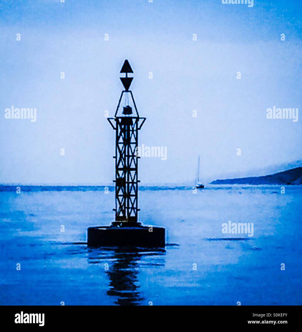East Cardinal Navigation Buoy with yacht sailing behind Stock Photo - Alamy