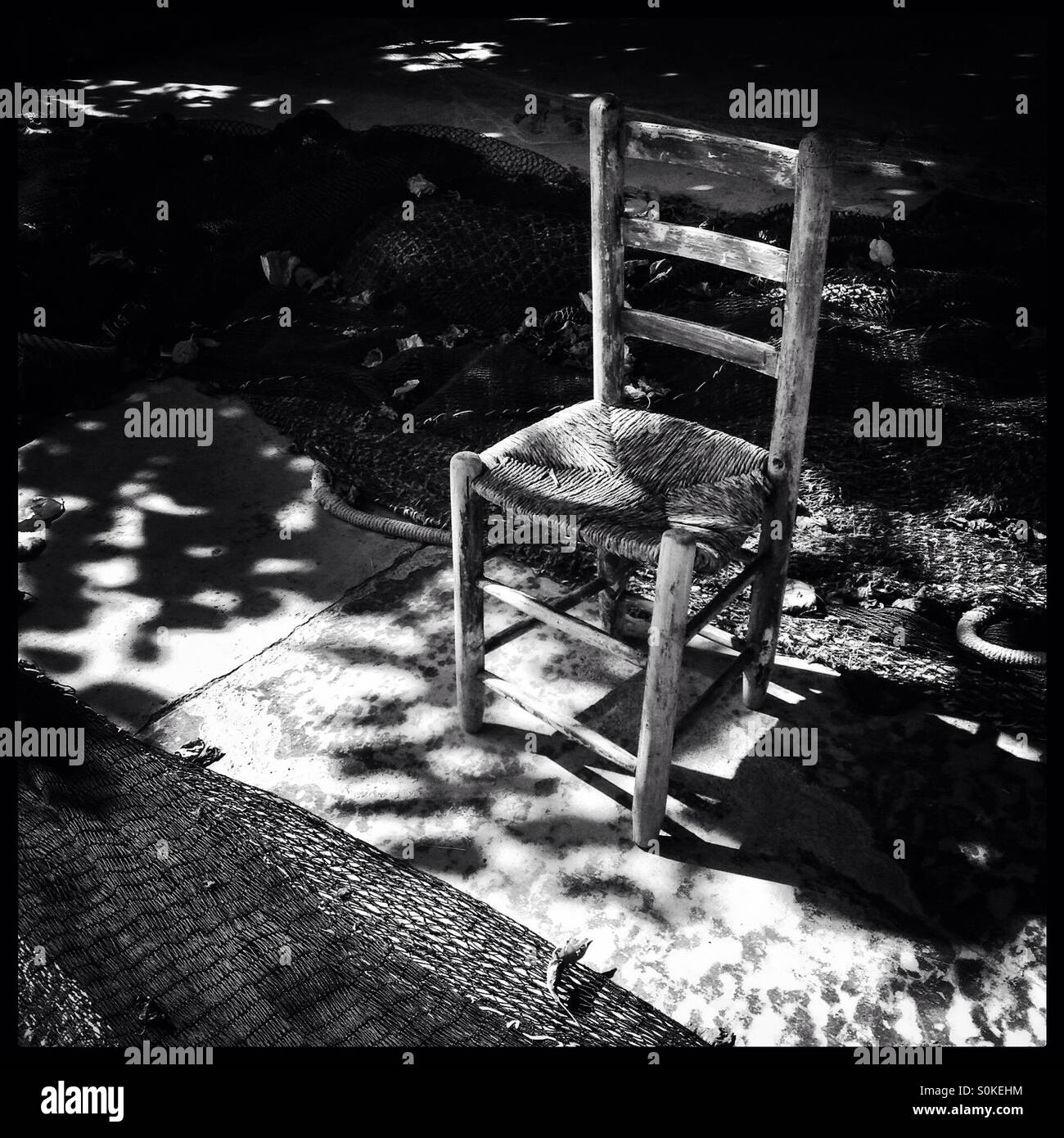 Chair between fishing nets, Cambrils, Spain. - Smartphone Captured Stock Image