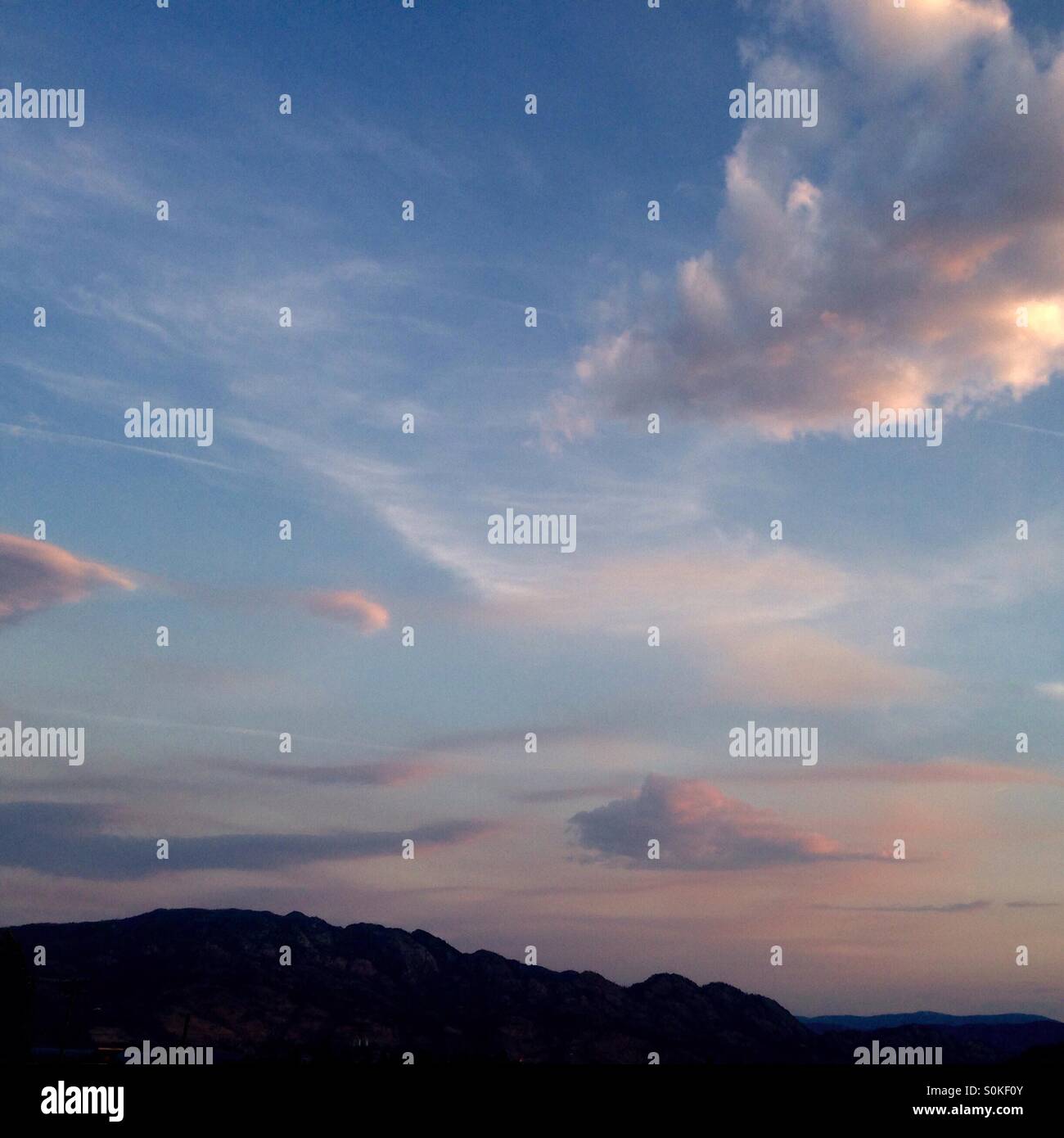 Sunset over mountains with beautiful clouds - Smartphone Captured Stock Image