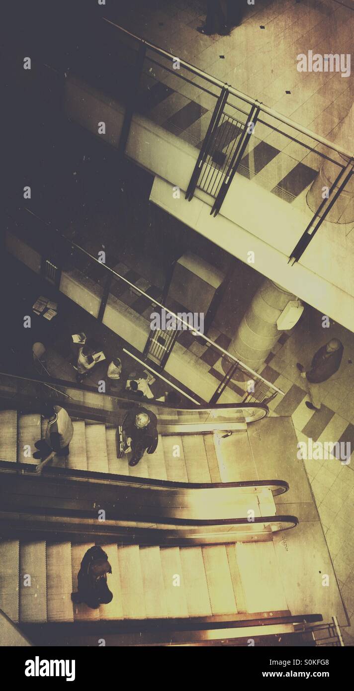 Going up and down. Crisscrossing. People in a shopping mall. - Smartphone Captured Stock Image