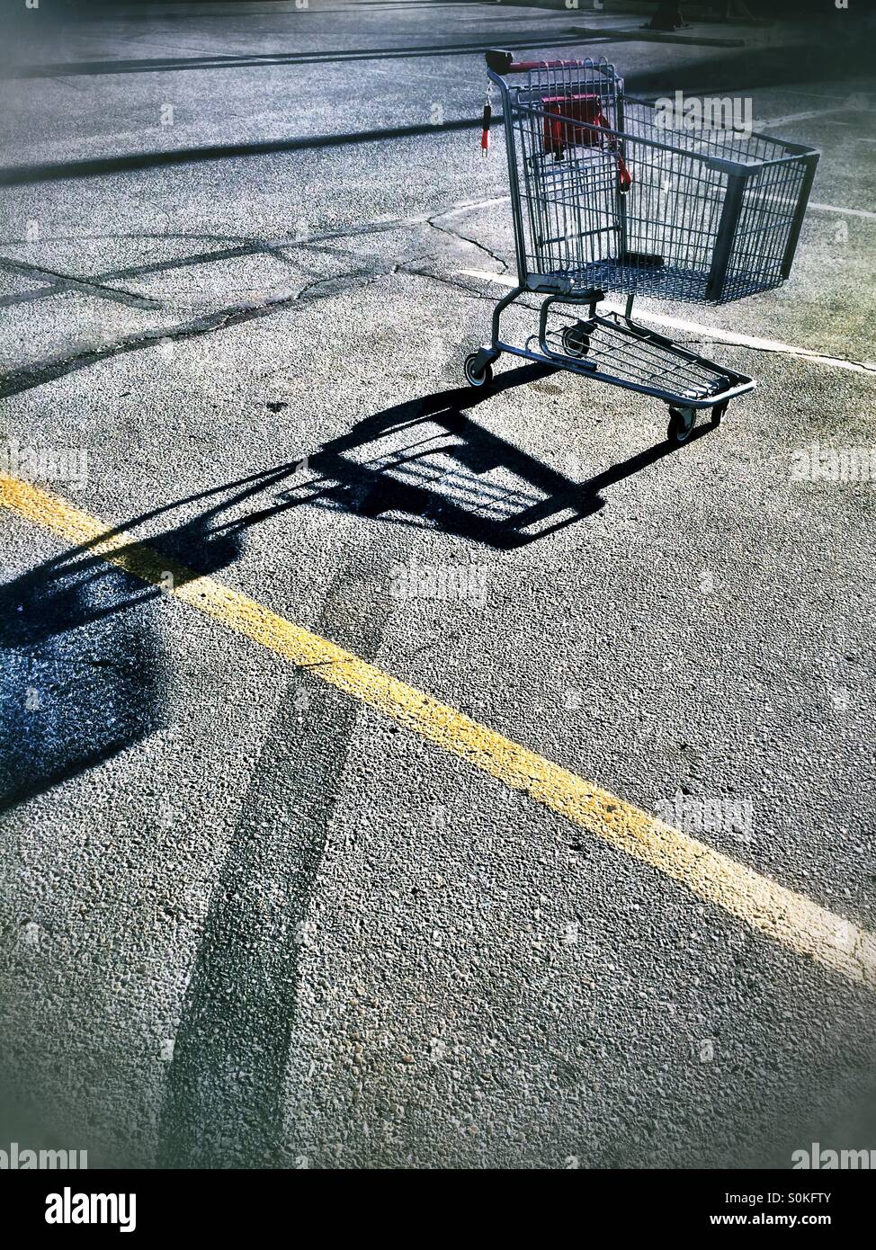 Shopping cart alone in a parking lot Stock Photo Alamy