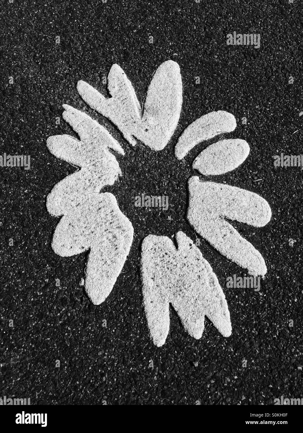 Flower motif on Tarmac Stock Photo - Alamy