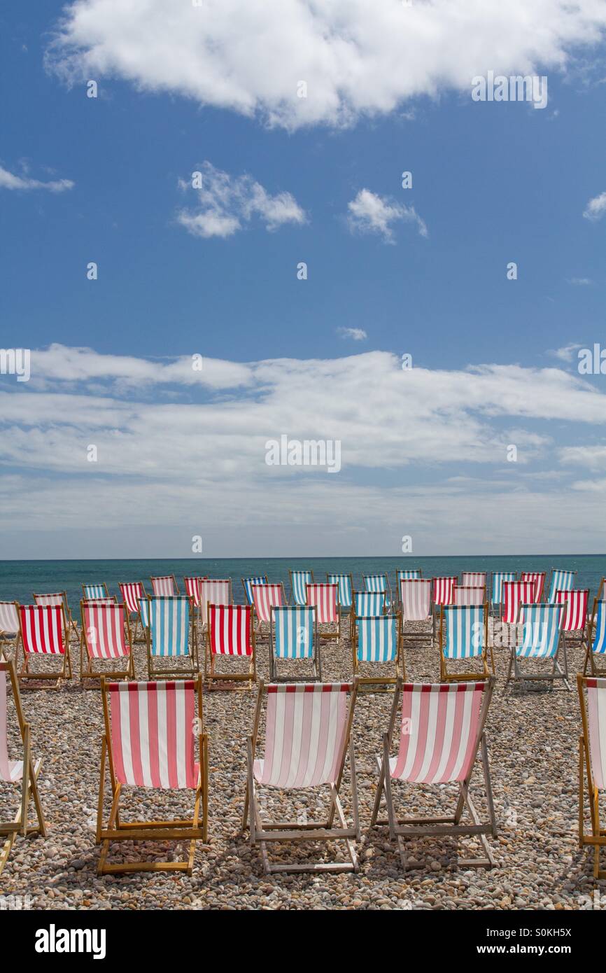 Rows of empty deckchairs face the sea on a deserted beach. - Smartphone Captured Stock Image