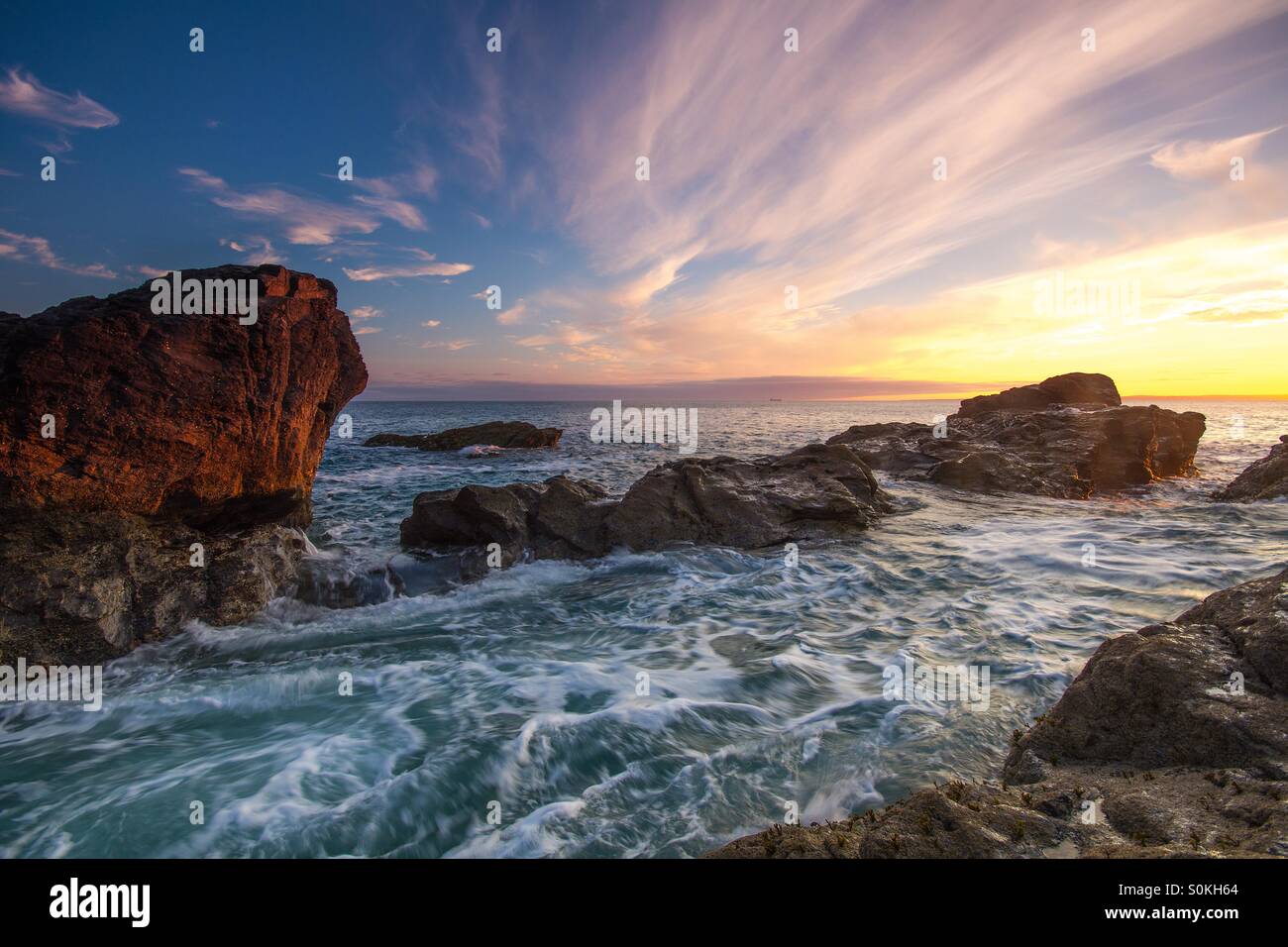 A coastal scene of water flowing over rocks in Cornwall, England. - Smartphone Captured Stock Image