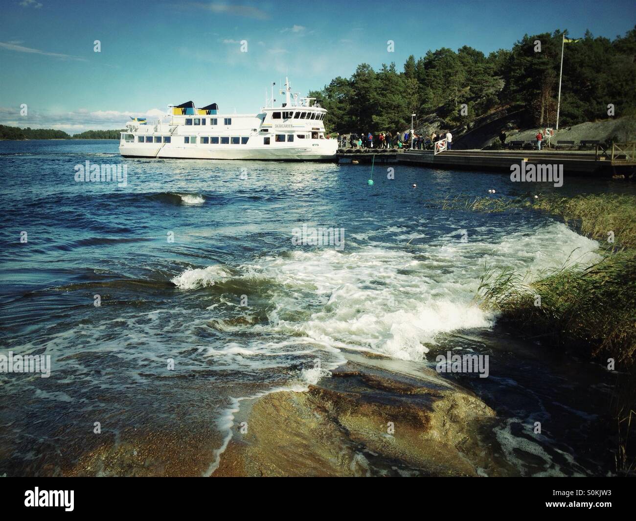 Ferry boat at jetty on Ingmarsö - island in Stockholm archipelago. - Smartphone Captured Stock Image